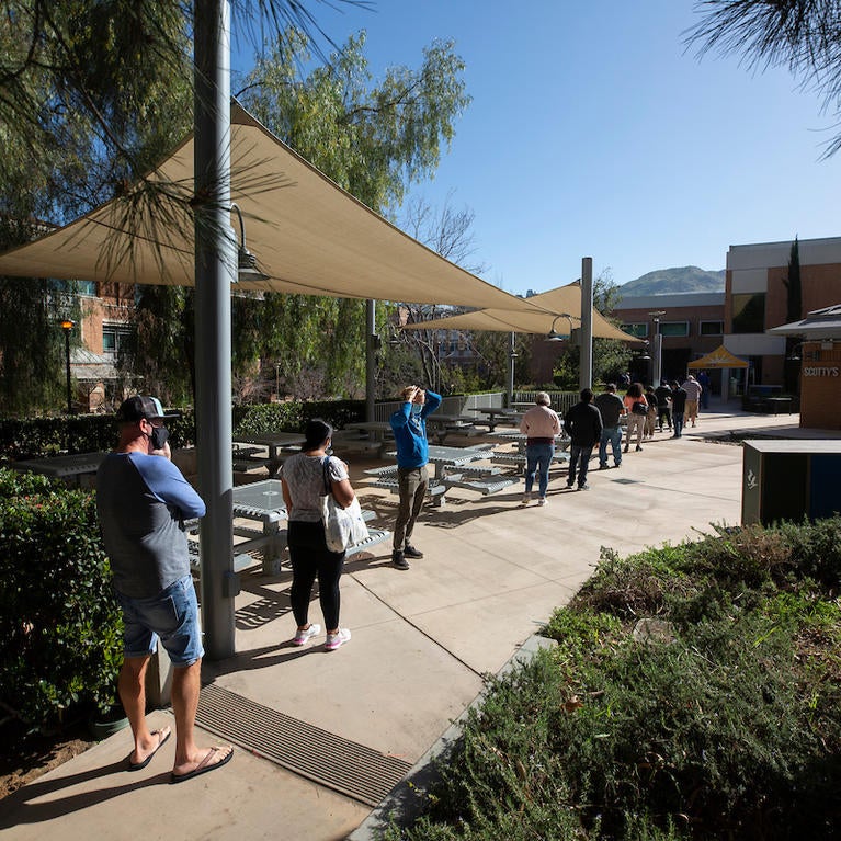 Employees line up at the COVID-19 vaccination clinic at the School of Medicine Education Building at UC Riverside on March 19, 2021.  (UCR/Stan Lim)